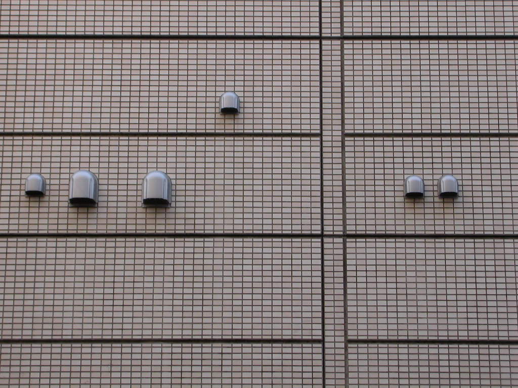 Like strange characters from an alien alphabet, these vents and their kin are scrawled all over the Tokyo streetscape.